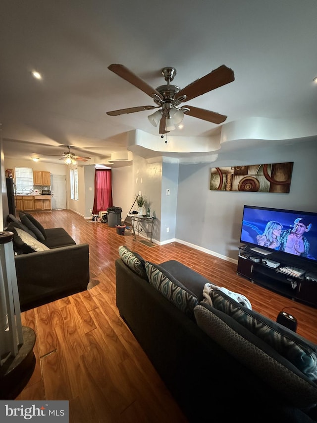 living room with hardwood / wood-style flooring and ceiling fan