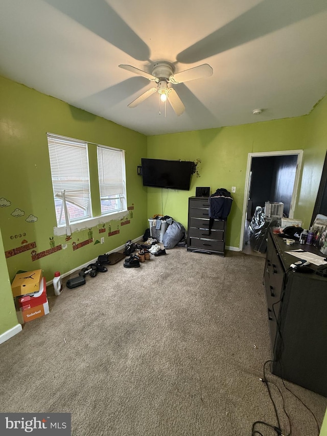 interior space featuring ceiling fan and carpet flooring