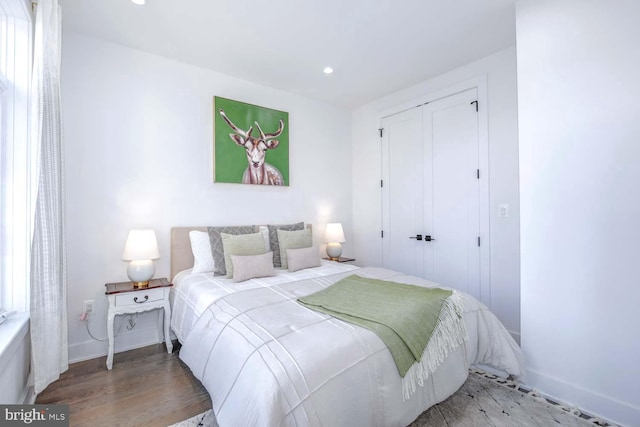 bedroom featuring hardwood / wood-style floors and a closet