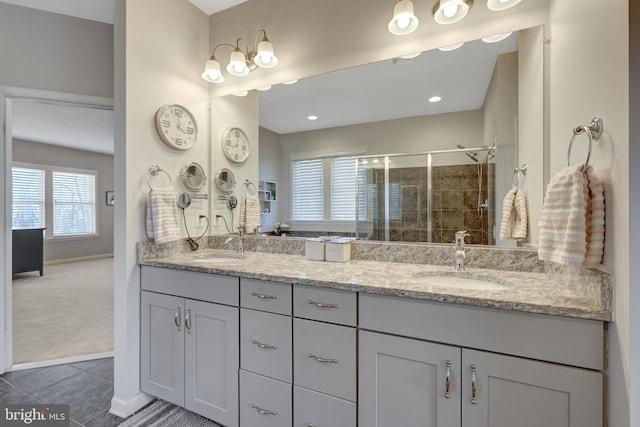 bathroom with vanity, an enclosed shower, and tile patterned floors