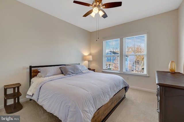 bedroom with light colored carpet and ceiling fan