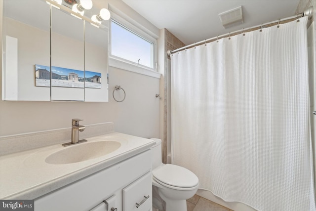 bathroom with tile patterned flooring, vanity, and toilet