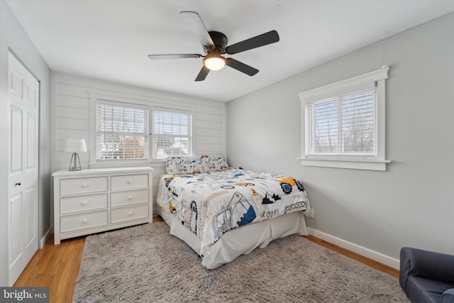 bedroom with ceiling fan and light hardwood / wood-style floors