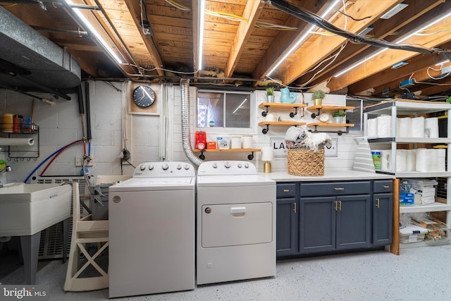 washroom featuring cabinets and separate washer and dryer