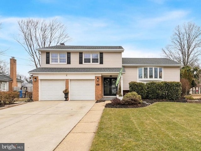 tri-level home featuring a garage and a front yard