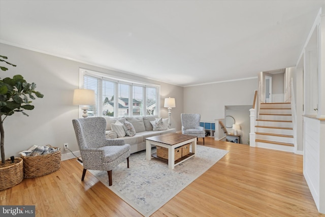 living room with ornamental molding and hardwood / wood-style floors