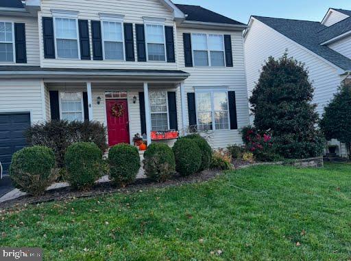 view of front of house with a garage and a front yard