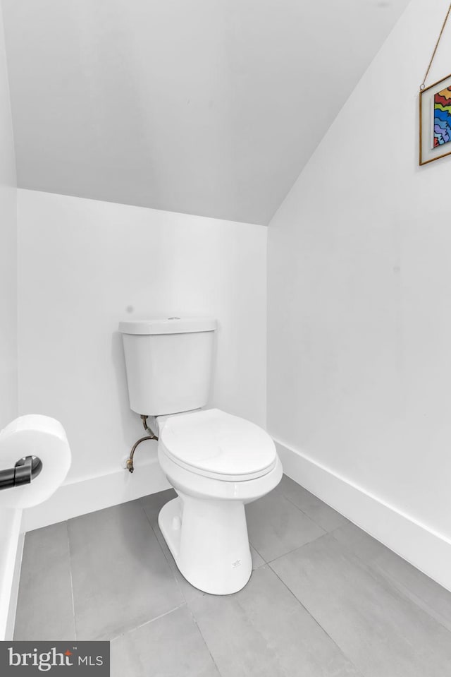 bathroom featuring vaulted ceiling, toilet, and tile patterned flooring