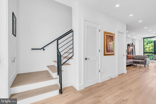 stairway with hardwood / wood-style floors