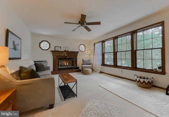 carpeted living room with ceiling fan