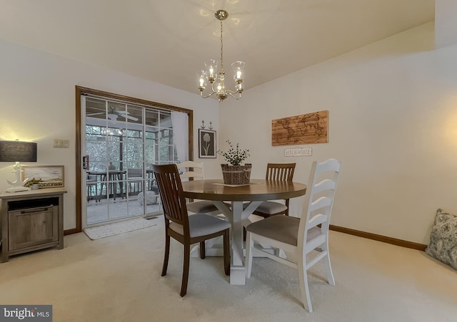 carpeted dining area with a notable chandelier