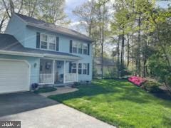 front facade featuring a garage and a front yard