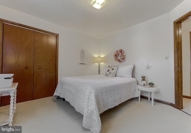 carpeted bedroom with a closet