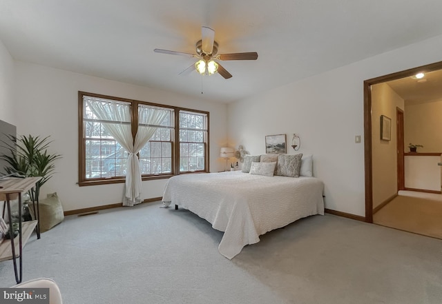 bedroom featuring ceiling fan and light carpet