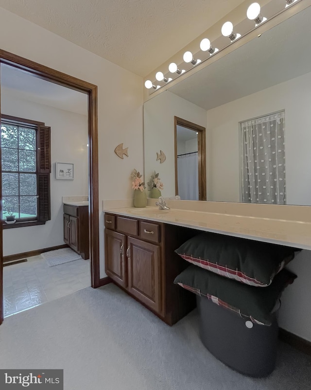 bathroom featuring vanity and a textured ceiling