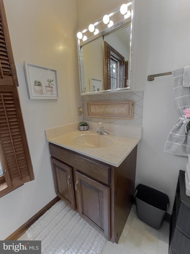 bathroom featuring vanity and backsplash