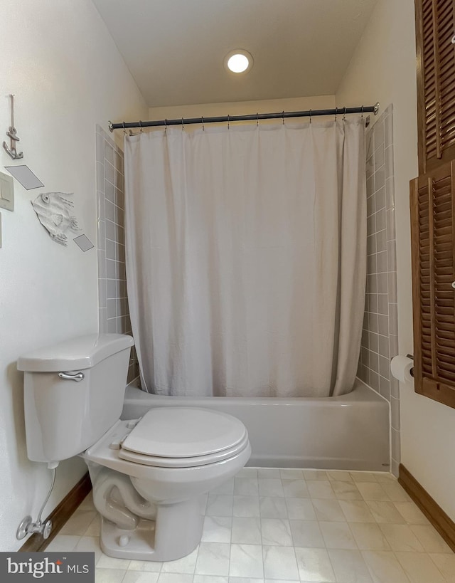 bathroom with toilet and shower / bath combo with shower curtain