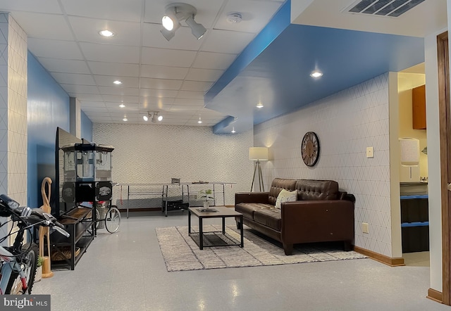 living room featuring a paneled ceiling