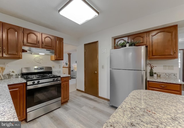 kitchen with stainless steel appliances and light wood-type flooring