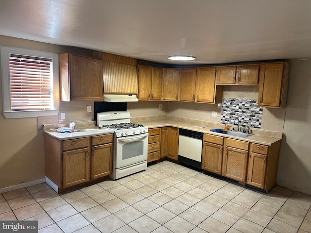 kitchen with tasteful backsplash, sink, white appliances, and light tile patterned flooring