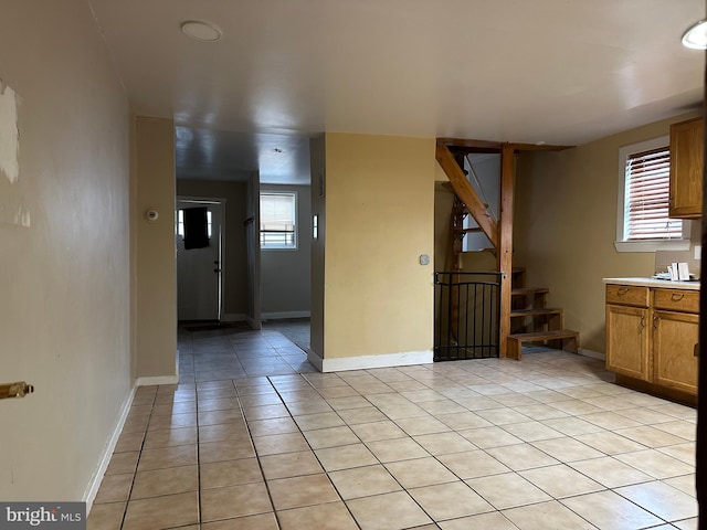 kitchen featuring light tile patterned floors and a healthy amount of sunlight