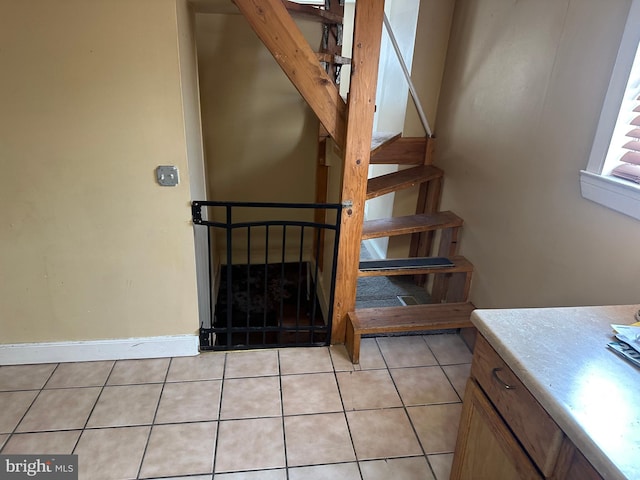 staircase featuring tile patterned flooring