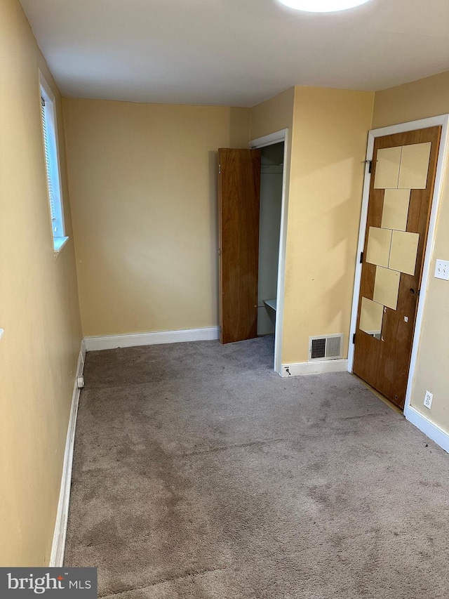 unfurnished room with carpet floors