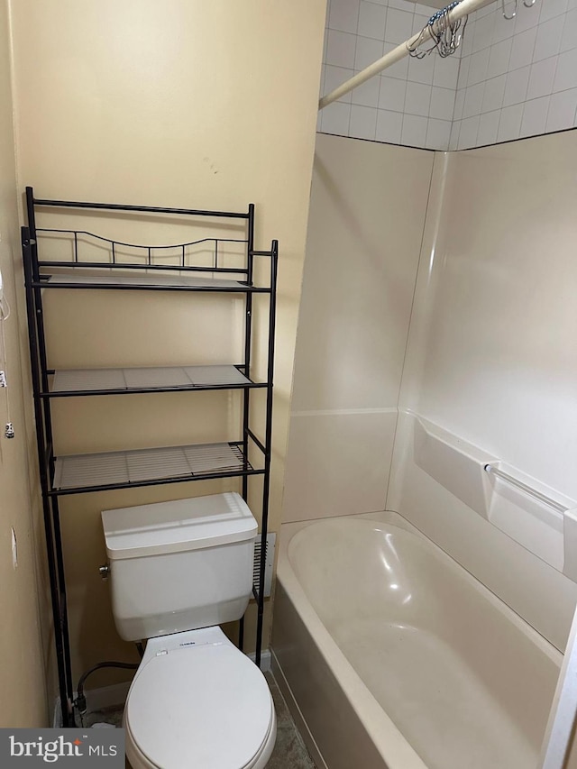 bathroom with shower / bathing tub combination and toilet