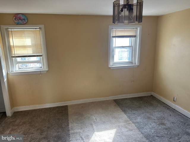 carpeted spare room featuring a wealth of natural light