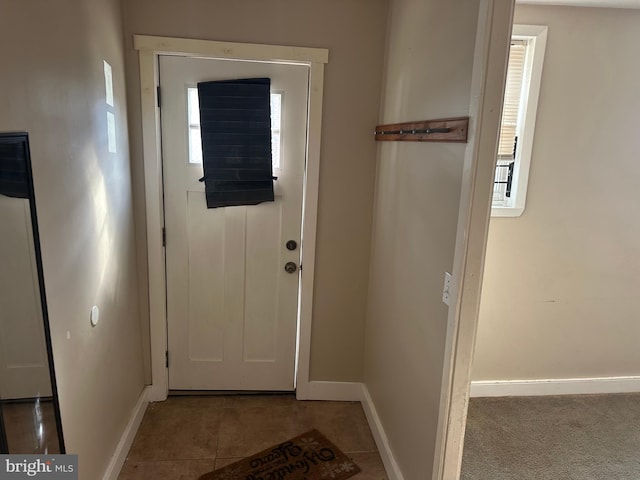 doorway with light tile patterned flooring