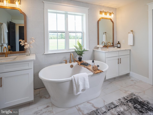 bathroom with vanity and a tub