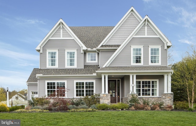 craftsman-style home featuring a porch and a front lawn