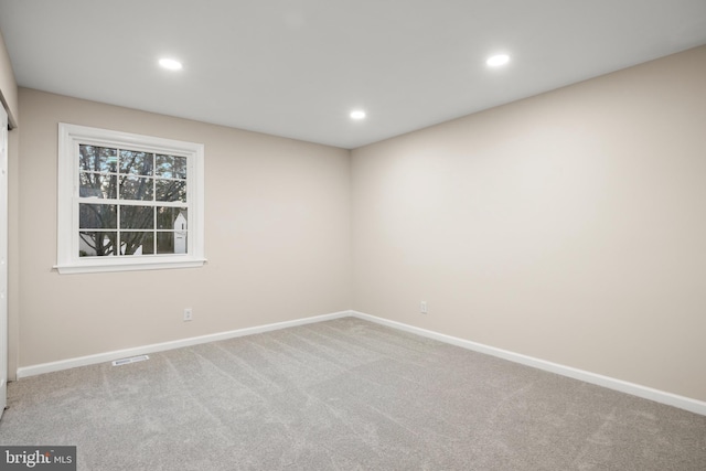 empty room with baseboards, carpet, and recessed lighting