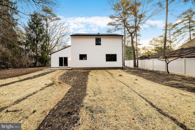 back of house with fence