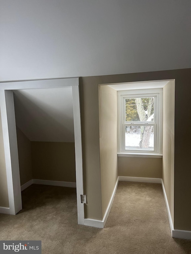 bonus room with vaulted ceiling, carpet floors, and baseboards