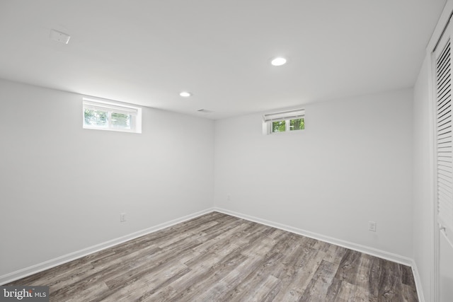 basement featuring plenty of natural light and light wood-type flooring