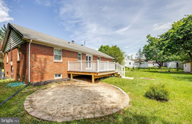 rear view of house featuring a wooden deck, a yard, and central AC unit