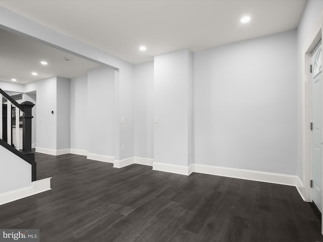 interior space featuring baseboards, dark wood-type flooring, stairway, and recessed lighting