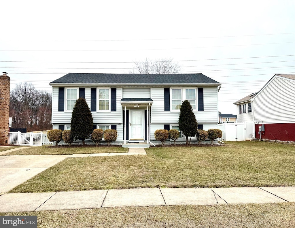 raised ranch featuring a front lawn