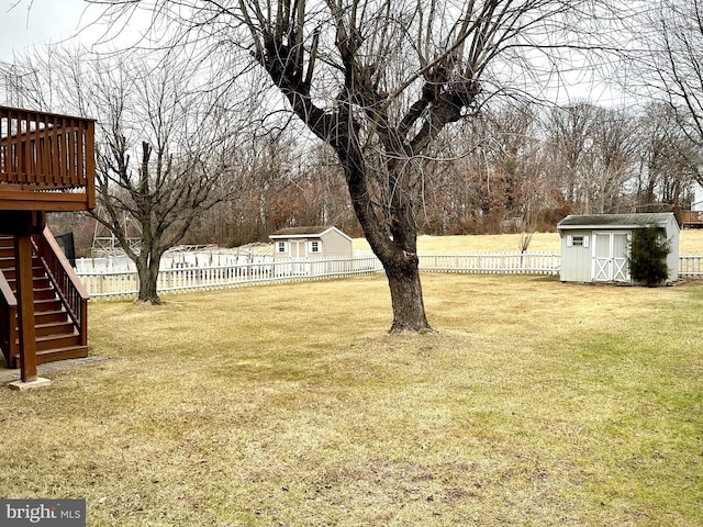 view of yard featuring a shed and a deck