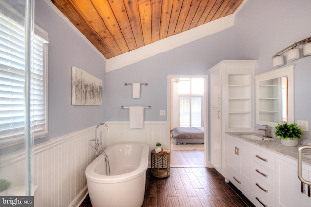 bathroom with vaulted ceiling, wooden ceiling, vanity, a bathtub, and hardwood / wood-style floors