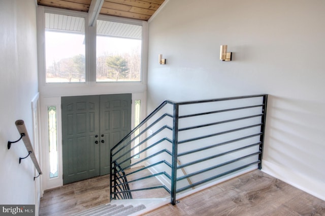 foyer entrance featuring lofted ceiling, wooden ceiling, and light hardwood / wood-style floors