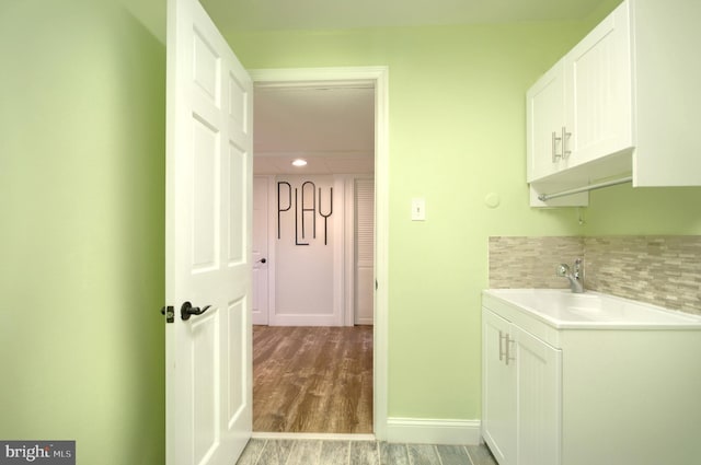 laundry area with hardwood / wood-style flooring