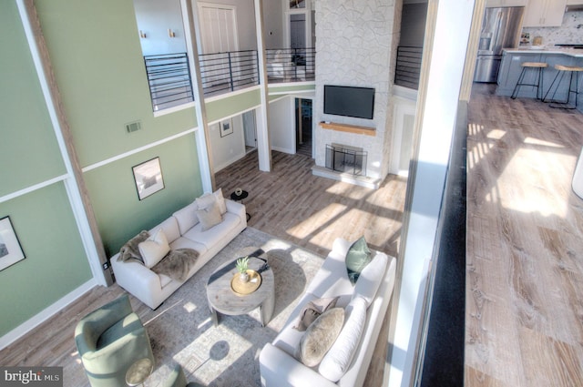 living room featuring a fireplace and light hardwood / wood-style flooring