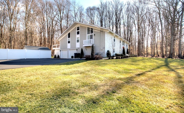 view of side of home featuring a yard and a garage