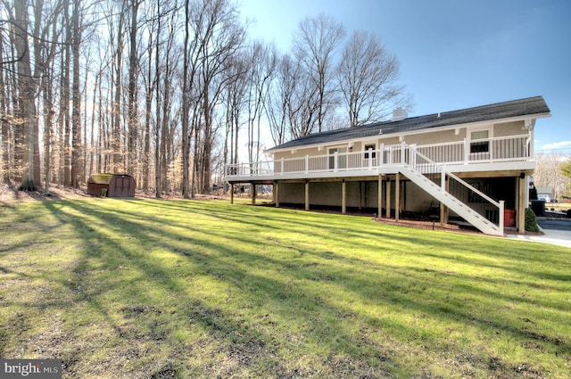 back of property with a shed, a deck, and a lawn