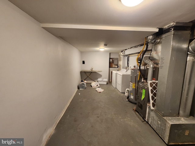 basement featuring water heater and washer and clothes dryer