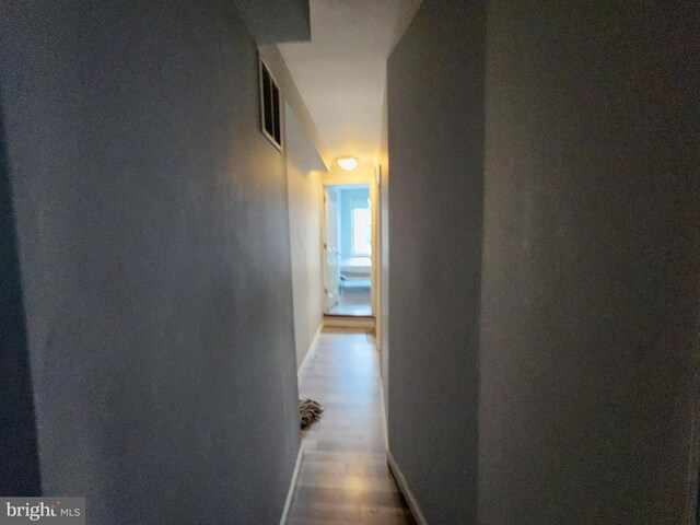 corridor featuring wood-type flooring