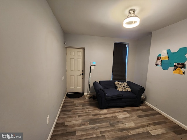 sitting room with dark hardwood / wood-style flooring