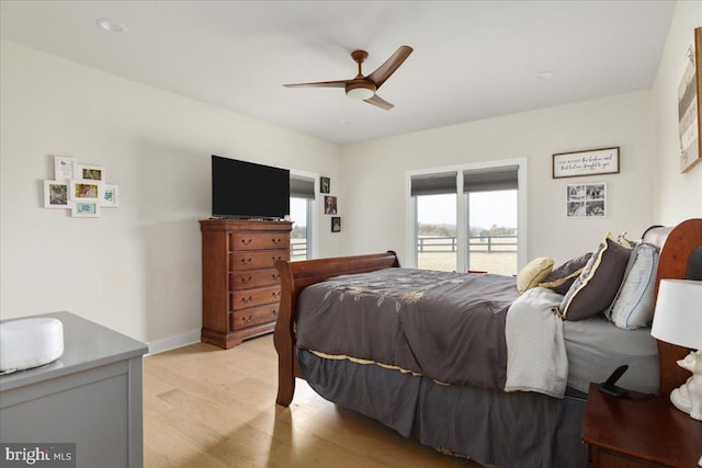 bedroom with access to exterior, ceiling fan, baseboards, and light wood finished floors